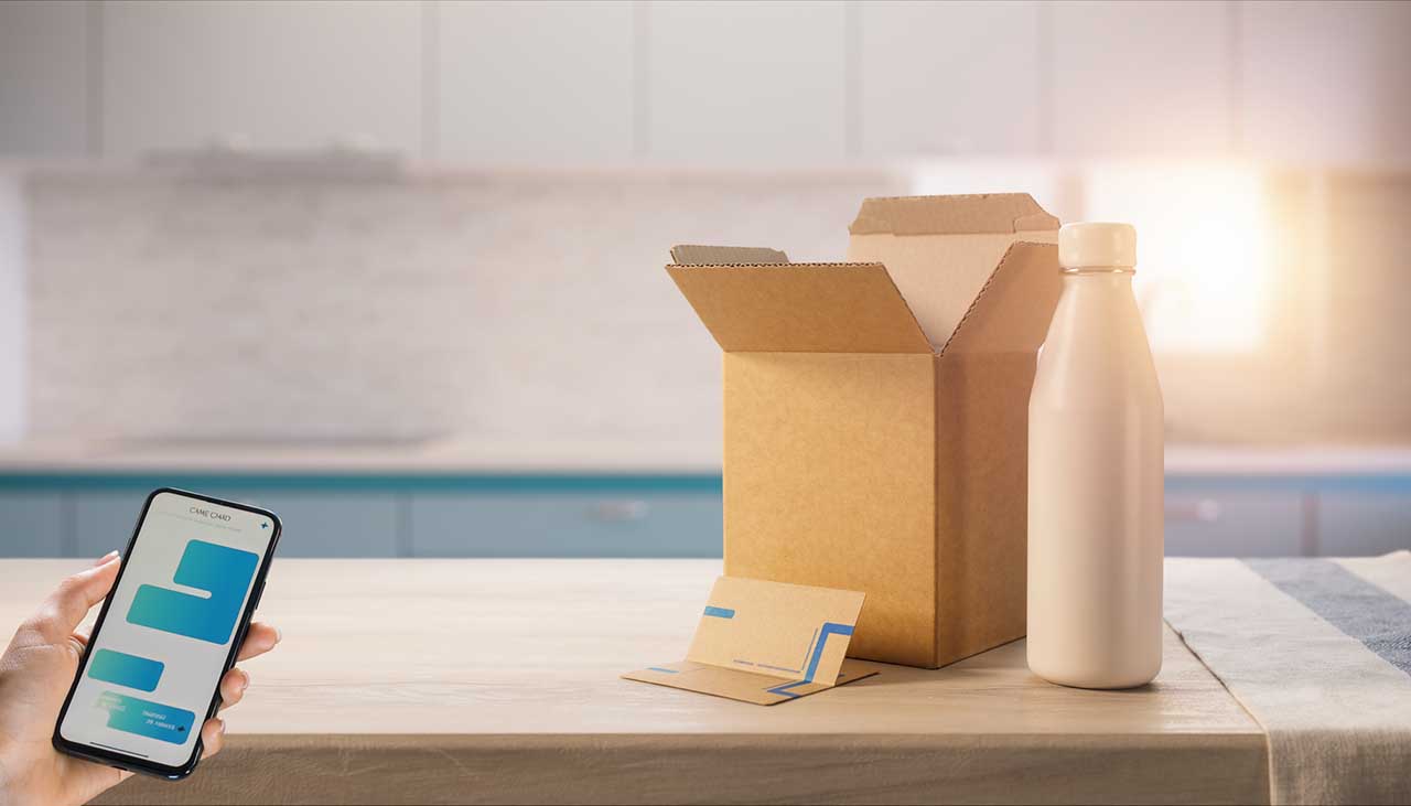 Illustrative product-care moment with an unbranded reusable bottle, packaging and a phone showing a guide